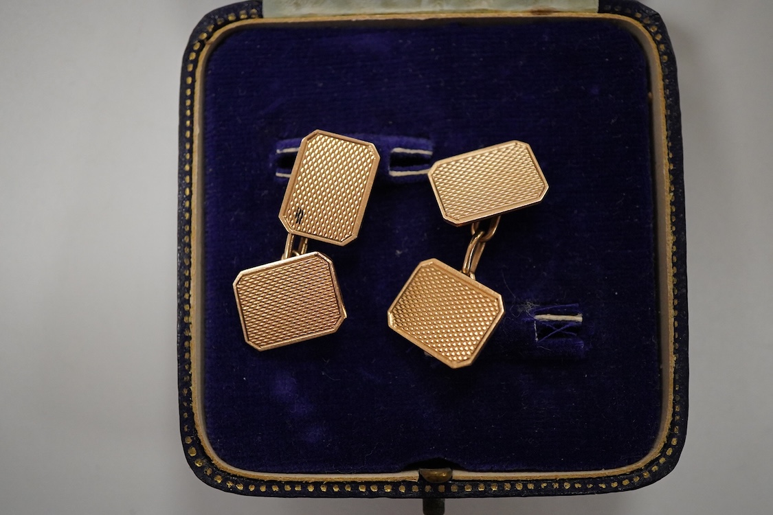 A pair of 1940's engine turned 9ct gold rectangular cufflinks by W. Wilkinson Ltd, 18mm, 6.5 grams, housed in a Mappin & Webb box.